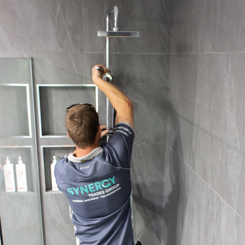 Synergy Trades Group - Plumbers in Action - installing a hot water system