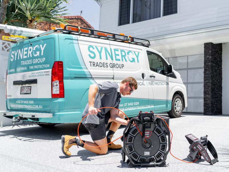 Synergy Trades Group - Plumbers in Action - Our plumber is ready to roll up